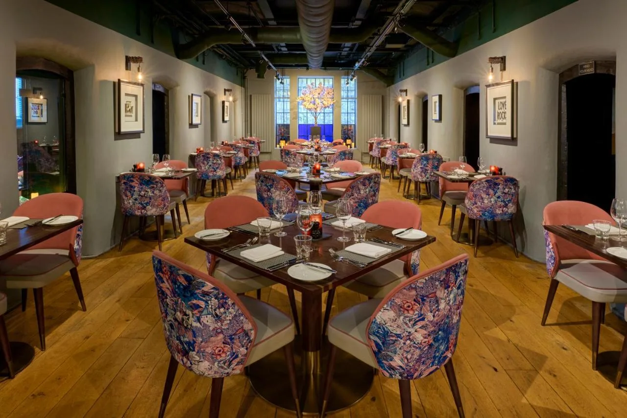 brasserie dining room with tables and a large window at Malmaison Oxford, Oxford