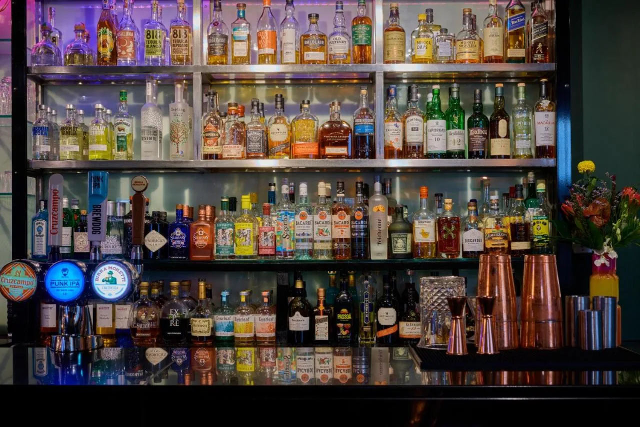 shelf of spirits and wine bottles at the bar in Malmaison Oxford